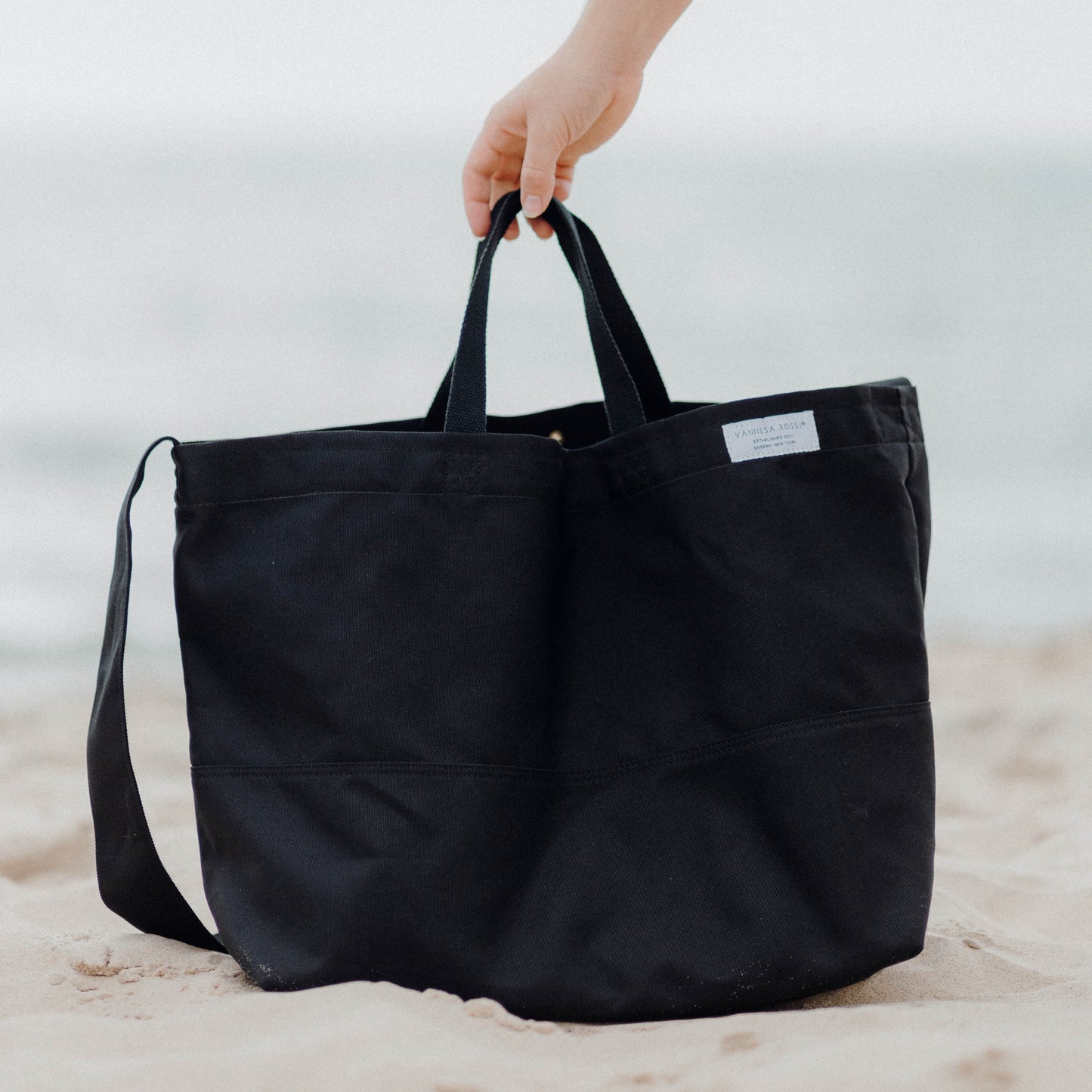 Linden Carryall - Spacious, water-resistant tote bag made from recycled materials. Features a removable pouch, is lightweight, machine washable, and folds for easy storage. Perfect for weekend getaways, beach trips, or everyday use.
